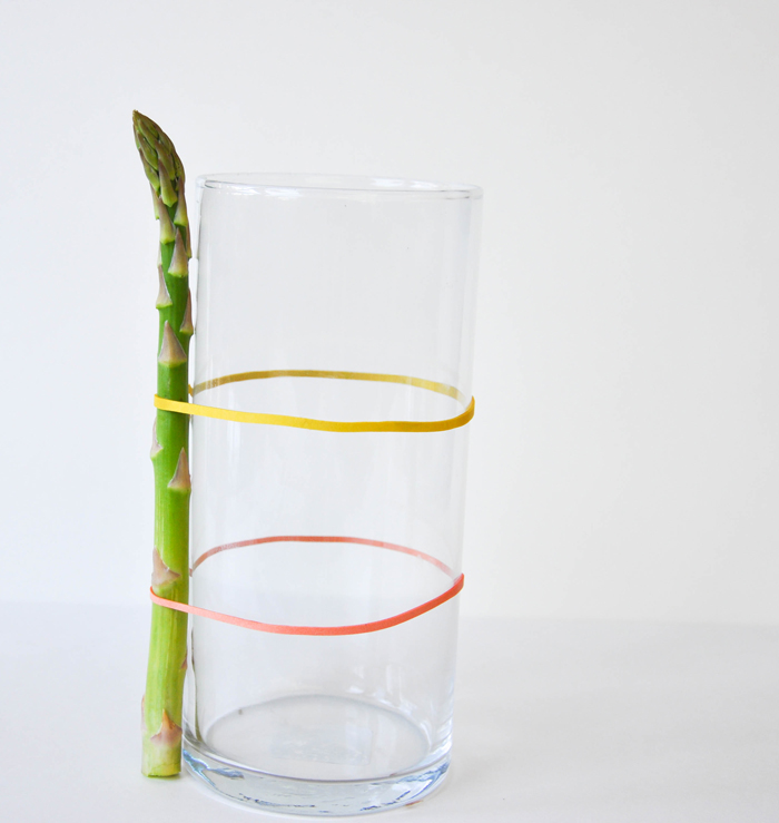 Cover a cylinder vase with fresh asparagus and fill with spring flowers!