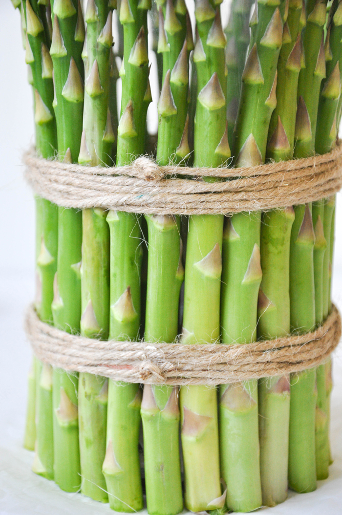 Cover a cylinder vase with fresh asparagus and fill with spring flowers!