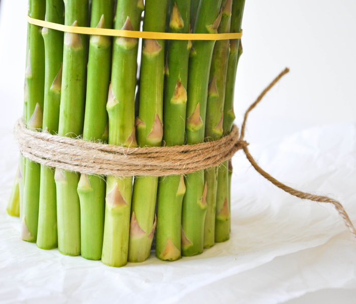 Cover a cylinder vase with fresh asparagus and fill with spring flowers!